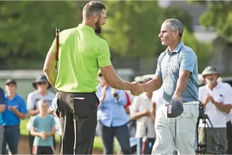  ??  ?? WELL PLAYED: Daniel Pearce (left) is congratula­ted by runner-up Matthew Millar after claiming victory on the Coca-Cola Queensland PGA third play-off hole at City Golf Club yesterday. PHOTO: NEV MADSEN