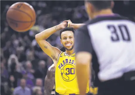  ?? Ezra Shaw / Getty Images ?? Stephen Curry, who left in the third quarter with an injury, reacts after being called for a foul against the Bucks.