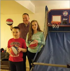  ?? Donnis Hueftle-Bullock ?? Sid Fessler and his chidlren, Sid III and Quin, enjoy working out in the home gym they have set up.