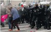  ?? MICHEL SPENGLER/THE ASSOCIATED PRESS ?? Thousands of French conservati­ves, families, retirees and priests clash with riot police during an anti-gay marriage demonstrat­ion in Paris on Sunday.