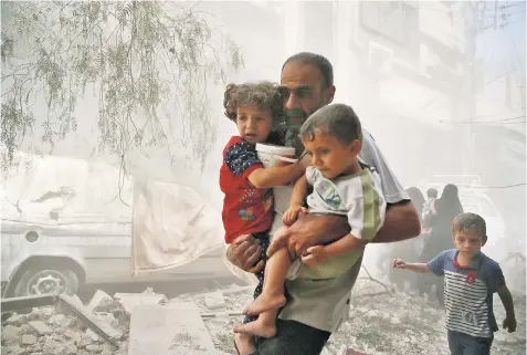  ??  ?? Children are pulled from the rubble after an air strike on a Damascus suburb. Waseem Ajaj, left, and Ali Daqneesh, below, brother of Omran, are among the victims of the war