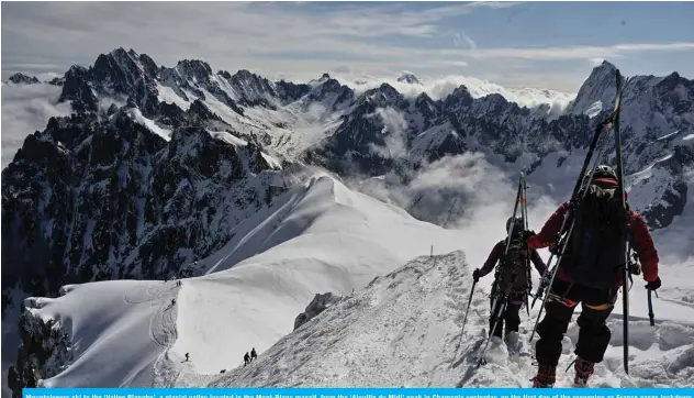  ?? — AFP ?? Mountainee­rs ski to the ‘Vallee Blanche’, a glacial valley located in the Mont-Blanc massif, from the ‘Aiguille du Midi’ peak in Chamonix yesterday, on the first day of the reopening as France eases lockdown measures taken to curb the spread of the COVID-19 pandemic.