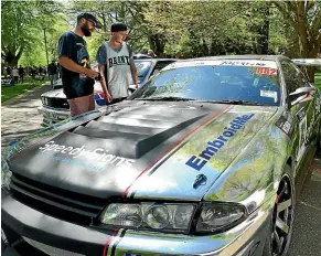  ??  ?? Craig Rogers and Oliver Walker admire the slick silver and black Nissan R33.