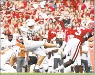  ?? Ronald Martinez / Getty Images ?? Texas’ Cameron Dicker kicks the winning field goal against Oklahoma in the AT&amp;T Red River Showdown at the Cotton Bowl on Saturday.