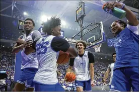  ?? JAMES CRISP/ASSOCIATED PRESS ?? Kareem Watkins (25) is congratula­ted by teammates after his dunk during Kentucky’s NCAA college basketball season kickoff event, Big Blue Madness, in Lexington, Kentucky, on Oct. 15.