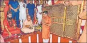  ?? PTI ?? CM Yogi Adityanath with Mahant of Baghambari Math Balveer Giri Maharaj offers prayers at the Bade Hanuman temple in Prayagraj on Saturday