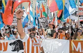  ?? EUGENE GARCIA/EPA ?? Immigratio­n rights activists march while carrying the flags of multiple Latin American countries during a May Day rally in Los Angeles on Monday.