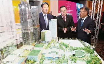  ??  ?? New landmark: (from left) Lendlease group chief executive officer and managing director Steve McCann, Lim and TRX City Sdn Bhd chief executive officer Datuk Azmar Talib viewing a model of the Lifestyle Quarter project.