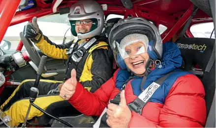  ?? JOHN HAWKINS/STUFF ?? Karen Barr is ready for a few fast laps of Teretonga Park with rally driver Kevin Lynch.