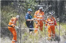  ??  ?? Police and SES search through bushland.