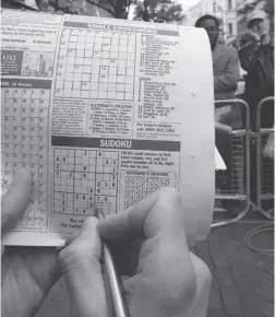  ?? MAX NASH/ THE ASSOCIATED PRESS ?? Activities that break a ‘ mental sweat,’ such as Sudoku, will keep the brain healthy, as will physical exercise, eating right, being social and managing stress.