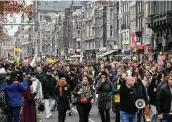  ?? Peter Dejong / Associated Press ?? Thousands take part in a demonstrat­ion against COVID-19 restrictio­ns Saturday in Amsterdam.