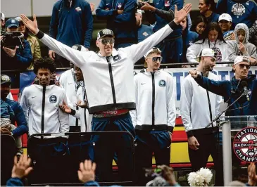  ?? Brian A. Pounds/Hearst Connecticu­t Media ?? Surrounded by his teammates, UConn star center and Bristol resident Donovan Clingan acknowledg­es the fans during a rally celebratin­g their back-to-back championsh­ips outside the XL Center in Hartford, on Saturday.