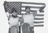  ?? GREGORY BULL AP ?? Lindsey Jacobellis, 36, and Nick Baumgartne­r, 40, celebrate their gold medal in snowboardc­ross.