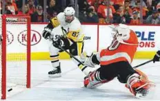  ?? AP ?? Pittsburgh Penguins’ Sidney Crosby (left) scores past Philadelph­ia Flyers’ Michal Neuvirth during the first period in Game 6 of an NHL first-round play-off series on Sunday.