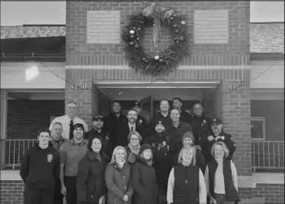  ?? Photos Courtesy of Plum Beach Garden Club ?? TOP LEFT: Members Elizabeth Lind, Nancy Donohue and Mel Kastanotis helping decorate Wickford Village. LEFT: Members Sue Colby and Linda Sollitto putting up trees in Old Library Park. TOP RIGHT: Honorary member inspecting the Meals on Wheels Work. ABOVE: PBGC President Andrea Sarrasin (front row, second from right) and several wreath team members, along with Police Chief Don Urban and Fire Chief Scott Kettelle.