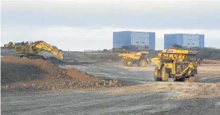  ?? EDF Energy ?? > 100-tonne dumpers working on the Hinkley Point C site, in front of Hinkley Point B in October 2014