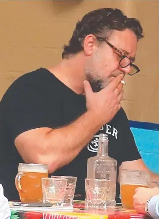  ??  ?? Actor Russell Crowe having a meeting and a beer in Surry Hills. Pictures: ADAM TAYLOR