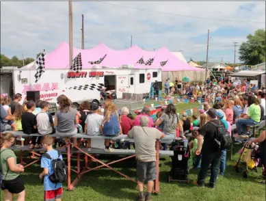  ?? LAUREN HALLIGAN - MEDIANEWS GROUP FILE ?? Eventgoers watch pig races on opening day of the 200th annual Schaghtico­ke Fair earlier this year.