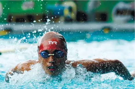  ?? (SUN.STAR FOTO/ALEX BADAYOS) ?? KING OF THE POOL. Michael Ichiro Kong had nine golds and four silver medals to help UC survive the surging University of San Carlos in the secondary division of the Milo Little Olympics.