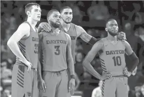  ?? GEOFF BURKE/USA TODAY SPORTS ?? Dayton forward Obi Toppin (1) stands with Flyers forward Ryan Mikesell (33), guard Trey Landers (3) and guard Jalen Crutcher (10) in the closing seconds of another victory this season.