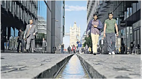  ??  ?? The Rill, a 285yd channel of water linking Tower Bridge, in the background, to London Bridge Station, which raised concerns after people using their phones were found to be falling in it while glued to their screens