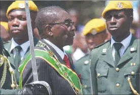  ?? PICTURE: AP ?? GETTING ON: Zimbabwean President Robert Mugabe inspects the guard of honour during the opening of the first session of the eighth parliament of Zimbabwe in Harare in September.