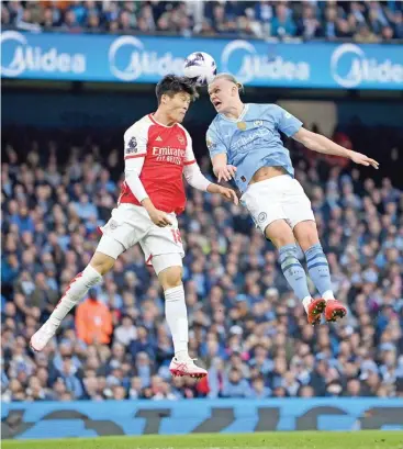  ?? ?? Arsenal’s Takehiro Tomiyasu (L) battles for the ball with Manchester City’s Erling Haaland