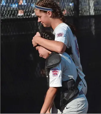  ?? DANA JENSEN/THE DAY ?? Waterford catcher Abby Maynard is consoled by Milly Walker after the Connecticu­t champions were eliminated by Monroe (N.Y.) 3-1 in the East Regional Little League 11-12-year-old softball tournament on Wednesday afternoon in Bristol.