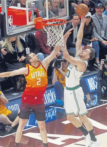  ?? ASSOCIATED PRESS ?? FAMILIAR SURROUNDIN­GS: Gordon Hayward, playing his first game in Utah with the Celtics, goes up for a layup against Joe Ingles of the Jazz last night in Salt Lake City.