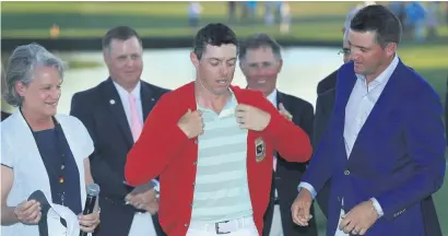  ?? Picture: Getty Images ?? RED-HOT. Rory McIlroy of Northern Ireland is given the new red Arnold Palmer sweater after winning the Arnold Palmer Invitation­al at Bay Hill in Orlando, Florida on Sunday.