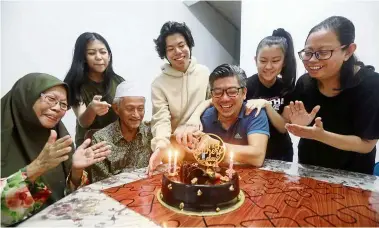 ??  ?? All together: Muhammad Roland (seated right) celebratin­g with his family. — SaMueL OnG/The Star