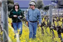 ?? Gary Coronado / Los Angeles Times ?? Cecilia Avina, left, talks with Arnulfo Solorio, manager of Silverado Farming, after pruning vineyards in California’s Napa Valley last month.