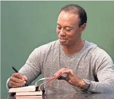  ?? SETH WENIG, AP ?? With the Masters two weeks away, Tiger Woods was signing copies of his book commemorat­ing his 1997 victory.