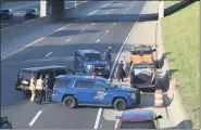  ?? MITCH HOTTS — THE MACOMB DAILY ?? Michigan State Police Police and Macomb County Medical Examiner vehicles and personnel on the scene of the crash on Interstate 94south of NineMile Road onMonday afternoon that killed a county road worker.