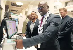  ?? Picture: SUNDAY TIMES ?? FASTER AND BETTER: Home Affairs Minister Malusi Gigaba demonstrat­es how the new Automated Biometric Identifica­tion System will work