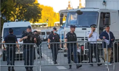  ?? Wednesday. Photograph: Christophe Petit-Tesson/EPA ?? French police officers secure the area before the arrival of a convoy transporti­ng Salah Abdeslam and other defendants to court in Paris on