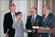  ?? MARCY NIGHSWANDE­R—ASSOCIATED PRESS ?? In this Aug. 10, 1993, file photo, Supreme Court Justice Ruth Bader Ginsburg takes the court oath from Chief Justice William Rehnquist, right, during a ceremony in the East Room of the White House in Washington. Ginsburg’s husband Martin holds the Bible and President Bill Clinton watches at left. The Supreme Court says Ginsburg has died of metastatic pancreatic cancer at age 87.