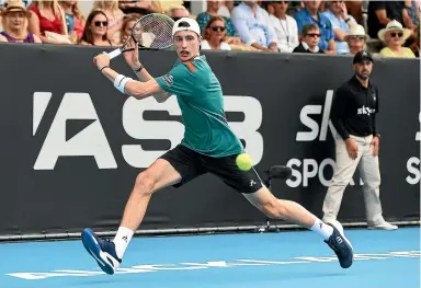  ?? PHOTOSPORT ?? France’s Ugo Humbert chases down a return during his straight sets semifinal win over American John Isner at the ASB Classic in Auckland yesterday.