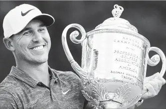  ?? ASSOCIATED PRESS FILE PHOTO ?? In this Aug. 12 photo, Brooks Koepka holds the Wanamaker Trophy after he won the PGA Championsh­ip golf tournament at Bellerive Country Club in St. Louis. Koepka has won PGA Tour player of the year. .