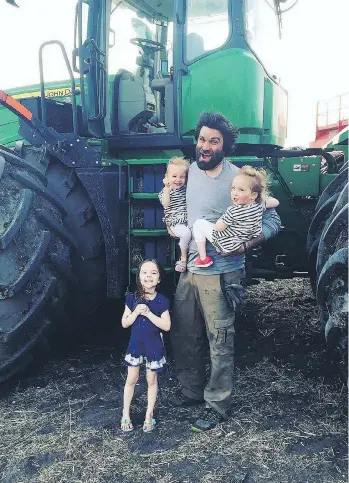  ?? TRAVIS HEIDE ?? Organic farmer Travis Heide poses with his daughters, left to right, Adora, 9, and twins Audrey, and Gia, 6, near Melfort, Sask. Despite his success, he gets sneers from truckers coming to pick up his crops.