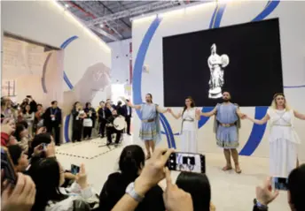  ??  ?? Greek dancers perform during the Second China Internatio­nal Import Expo in Shanghai on November 8