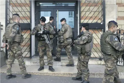  ?? MARTIN BUREAU/AFP/GETTY IMAGES ?? In the wake of the Charlie Hebdo attacks, an extra 2,000 police officers and 6,000 soldiers were deployed. But Paris also signed a “Pact against exclusion” to deal with the problem of homelessne­ss, after it was revealed that the perpetrato­rs had been...