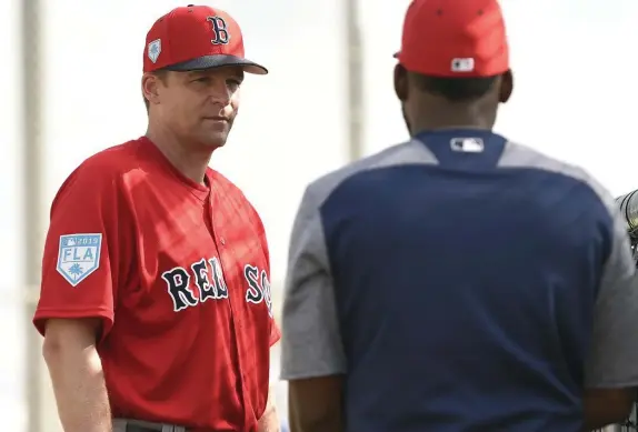  ?? HERALD STAFF FILE ?? UP CLOSE AND PERSONAL: Red Sox hitting coach Tim Hyers (left) talks with center fielder Jackie Bradley Jr. during a spring training workout in Fort Myers, Fla., in the spring of 2019.