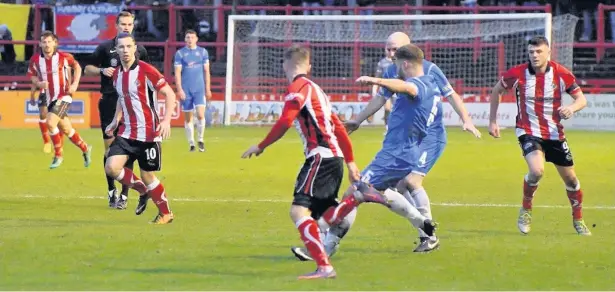  ?? Frank Crook ?? ● Luke Thompson breaking up an Altrincham attack during Saturday’s FA Trophy clash at Moss Lane, where the home side won 4-1