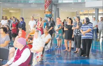  ??  ?? Many of those who observed two minutes’ silence at Te Ahu on Friday, seven days to the minute since the terrorist attacks on two Christchur­ch mosques, covered their hair in solidarity with the victims.