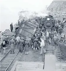  ?? Photo: ALEXANDER TURNBULL LIBRARY REF: 114/159/12-G ?? A crowd of people gather around two trains that collided on the railway line alongside the Hutt Road.