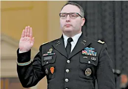  ?? ANDREW CABALLERO-REYNOLDS/GETTY-AFP 2019 ?? Lt. Col. Alexander Vindman is sworn in Nov. 19 at a House hearing in President Trump’s impeachmen­t case. Vindman’s attorney said the decorated Iraq War veteran is retiring.