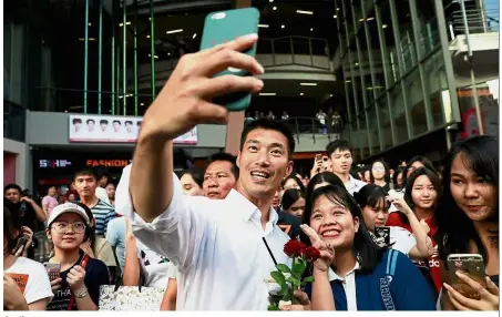  ?? — Reuters ?? Smile: Thanathorn taking a selfie with supporters during a campaign rally in Bangkok.