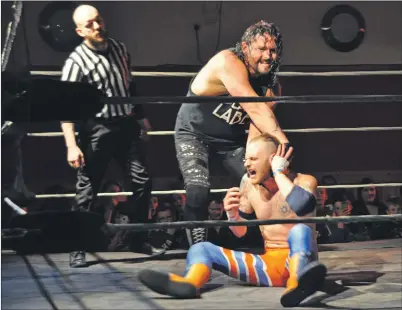  ?? Photos: Janet West ?? Ear twisting agony for one wrestler.